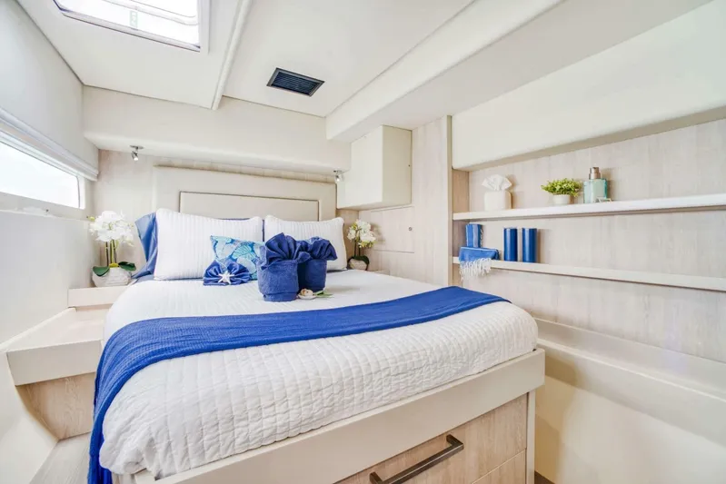 Deep Blue Yacht Photos Pics Luxurious bedroom interior on 2016 Leopard 58 Catamaran with elegant blue and white decor.