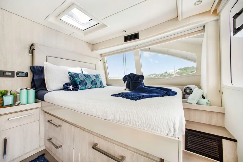 Deep Blue Yacht Photos Pics Luxurious bedroom interior of 2016 Leopard 58 Catamaran with modern decor and large window view.