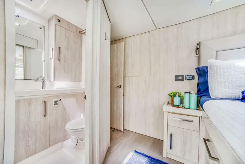 Deep Blue Yacht Photos Pics Interior of 2016 Leopard 58 Catamaran featuring modern bathroom and cozy bedroom.