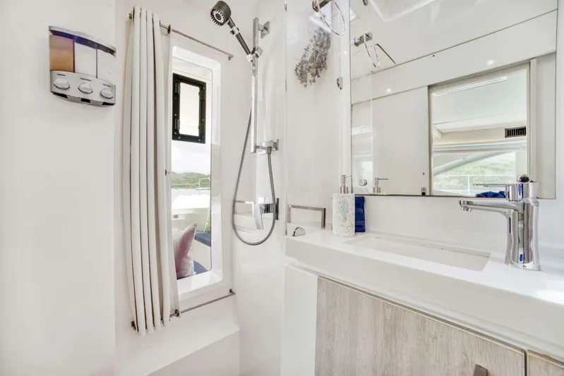 Deep Blue Yacht Photos Pics Modern bathroom interior of 2016 Leopard 58 Catamaran with sleek fixtures and window view.