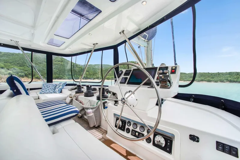 Deep Blue Yacht Photos Pics Luxurious 2016 Leopard 58 Catamaran cockpit with scenic ocean view and modern navigation equipment.