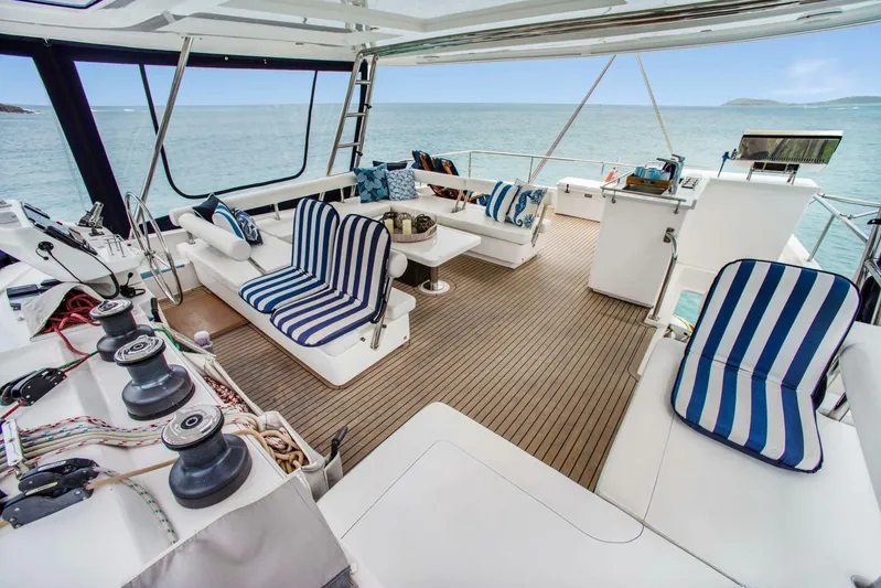 Deep Blue Yacht Photos Pics Luxurious 2016 Leopard 58 Catamaran deck with striped seating and ocean view.