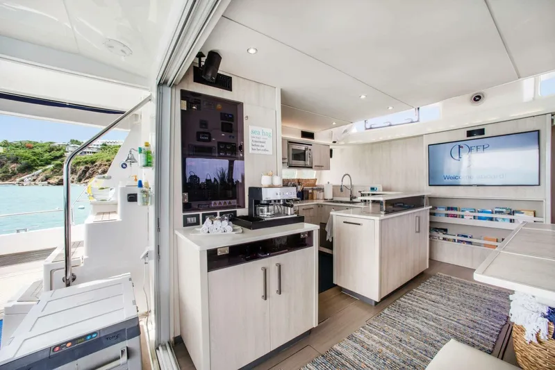 Deep Blue Yacht Photos Pics Luxurious interior of a 2016 Leopard 58 Catamaran with modern kitchen and ocean view.