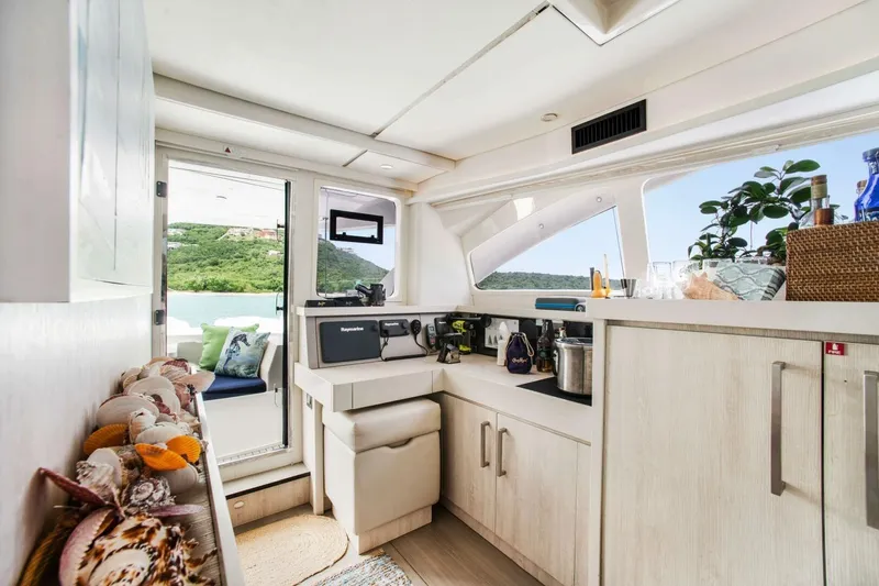 Deep Blue Yacht Photos Pics Interior of 2016 Leopard 58 Catamaran with modern kitchen and scenic window view.