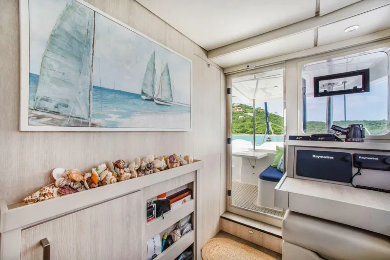 Deep Blue Yacht Photos Pics Interior of 2016 Leopard 58 Catamaran with seashells, artwork, and Raymarine equipment.