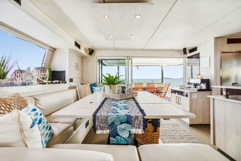 Deep Blue Yacht Photos Pics Luxurious interior of 2016 Leopard 58 Catamaran with elegant dining area and ocean view.