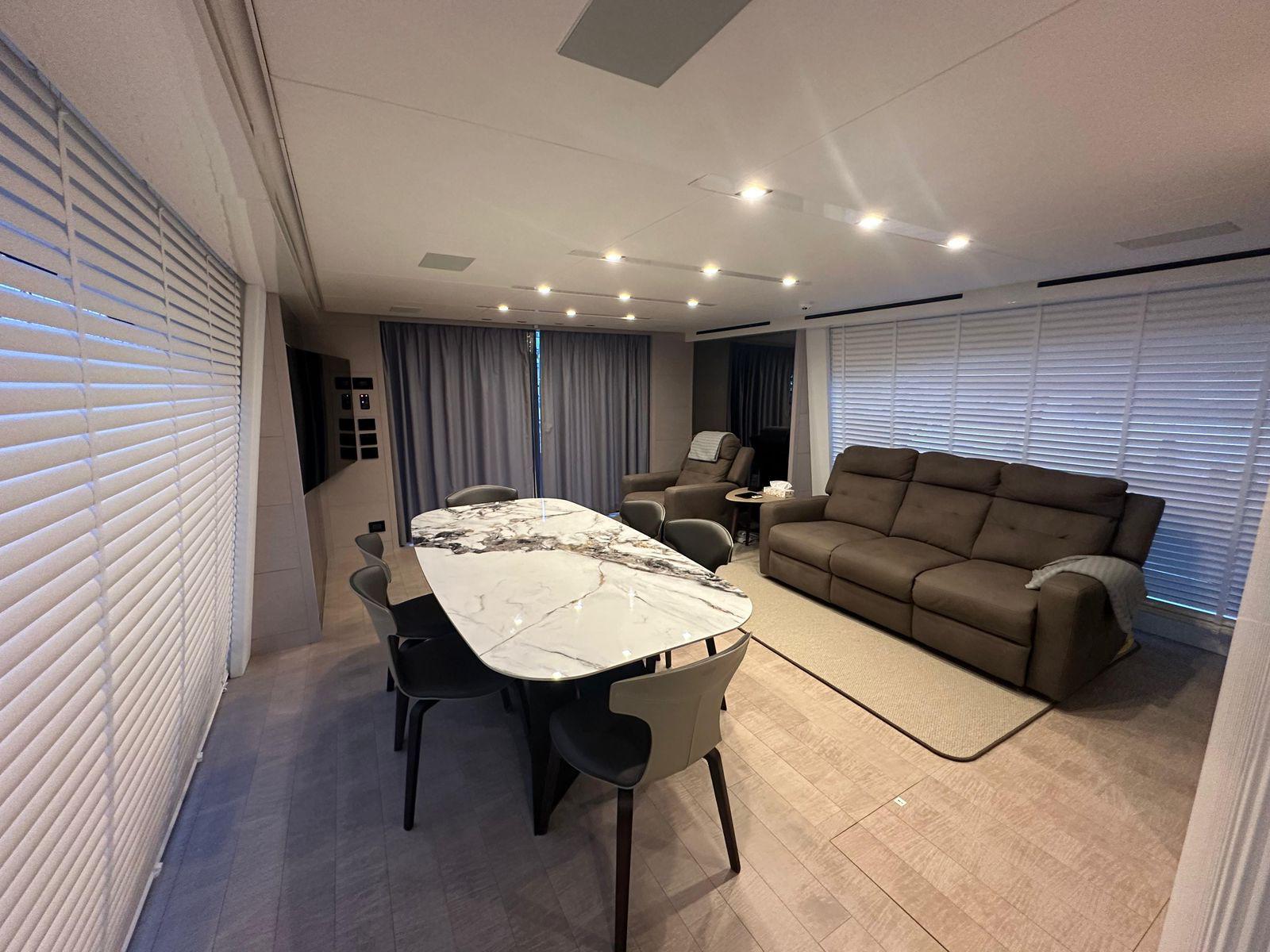 Luxurious interior of 2024 AB 80 with modern dining and living area.