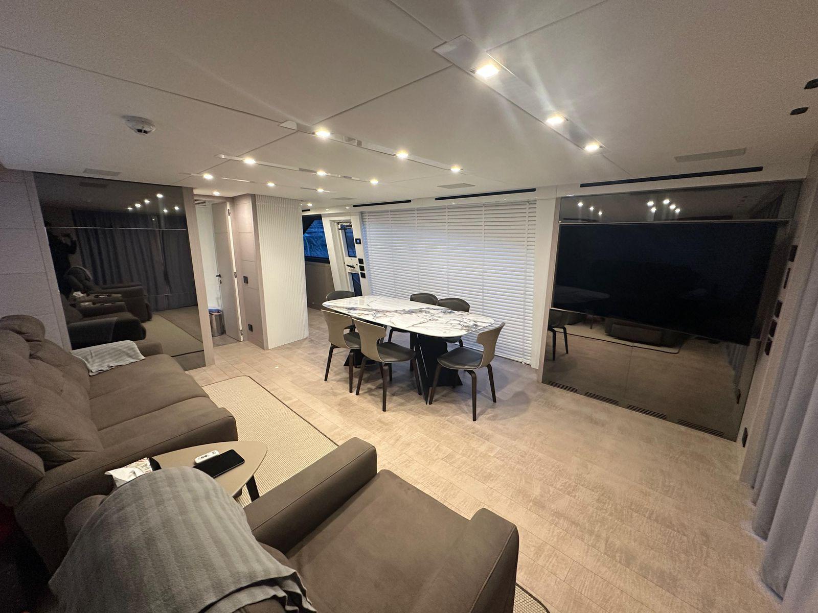 Luxurious interior of 2024 AB 80 yacht with modern seating and dining area.