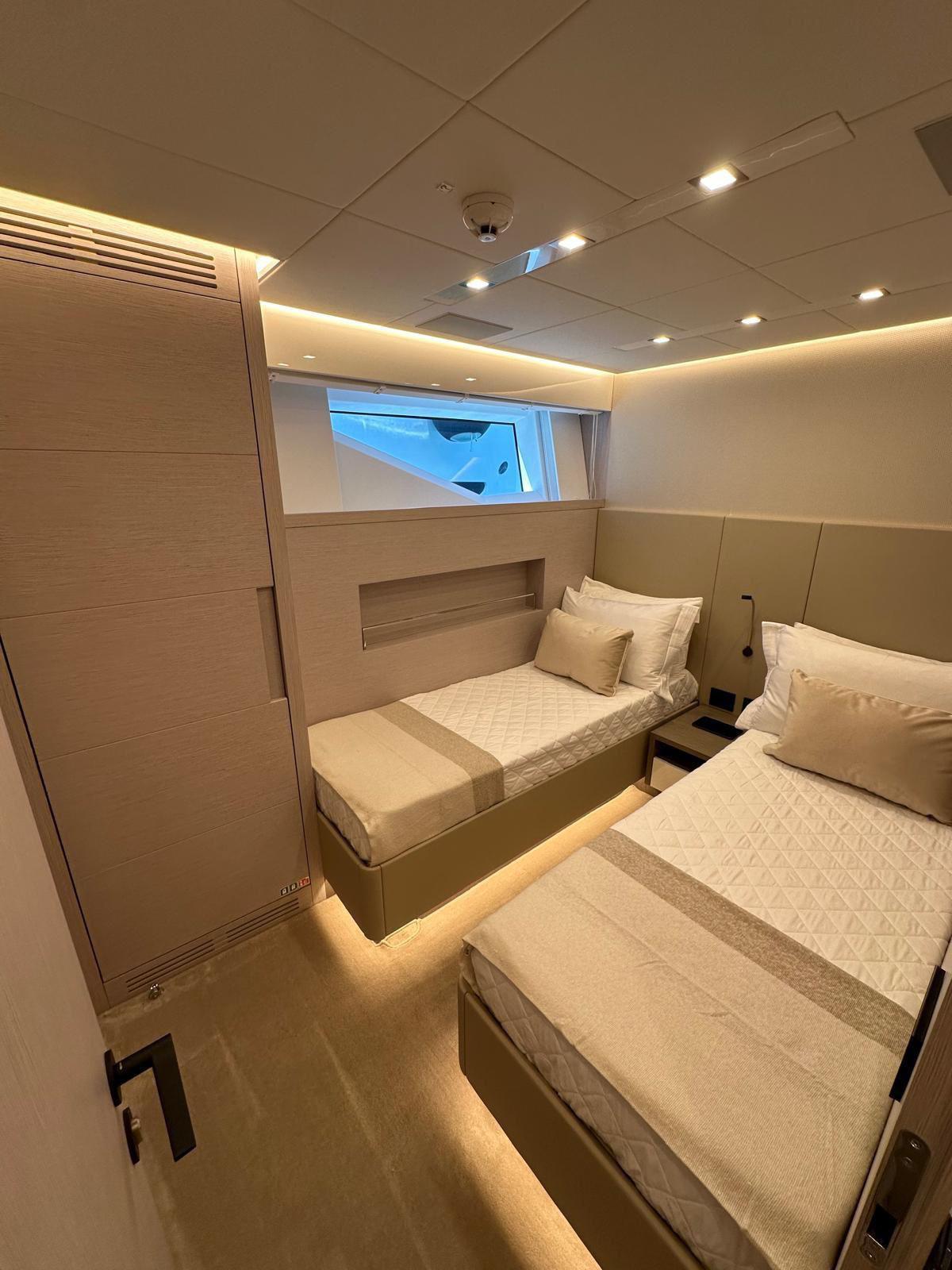Luxurious twin cabin in 2024 AB 80 yacht, featuring modern design and ambient lighting.