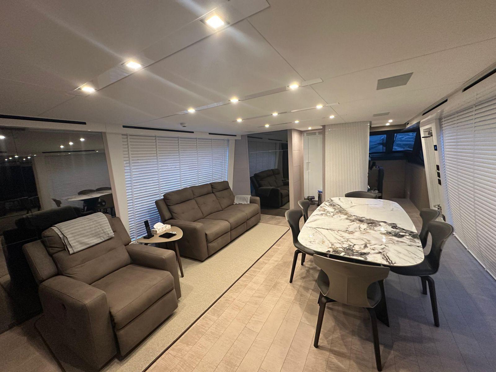Luxurious interior of 2024 AB 80 yacht with modern seating and elegant dining area.