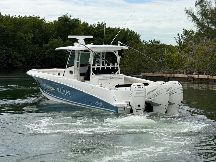  Yacht Photos Pics 2019 Boston Whaler 350 Outrage on calm water, surrounded by trees.