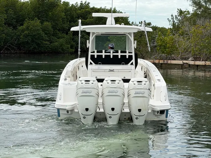  Yacht Photos Pics 2019 Boston Whaler 350 Outrage with triple outboard engines on calm water.