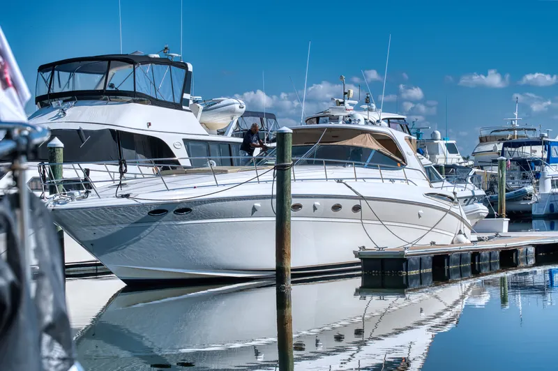 Couples Therapy Yacht Photos Pics 2001 Sea Ray 510 Sundancer yacht docked at marina, reflecting on calm water.