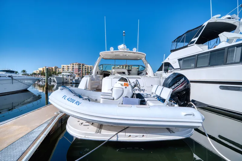 Couples Therapy Yacht Photos Pics 2001 Sea Ray 510 Sundancer yacht docked with inflatable boat and Mercury engine.
