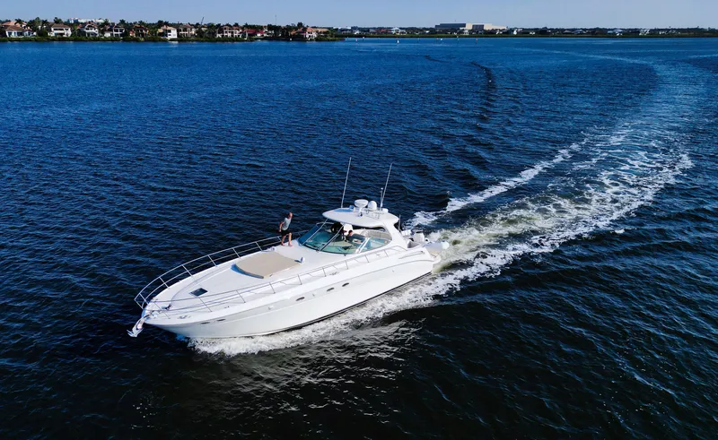 Couples Therapy Yacht Photos Pics 2001 Sea Ray 510 Sundancer cruising on open water, leaving a wake behind.