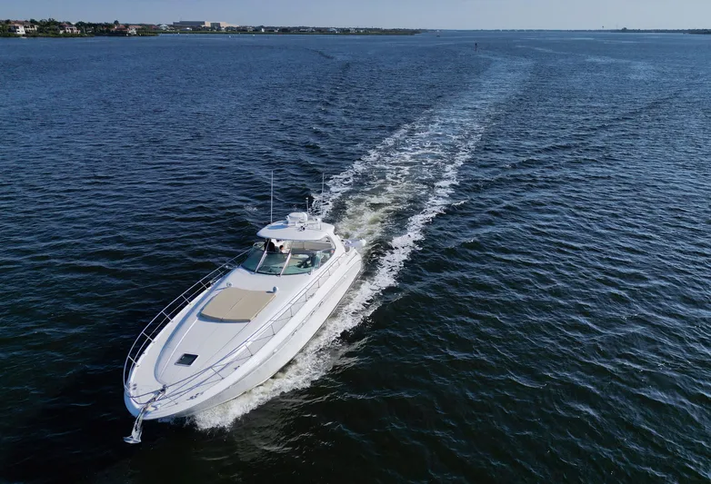 Couples Therapy Yacht Photos Pics 2001 Sea Ray 510 Sundancer cruising on open water, leaving a wake behind.