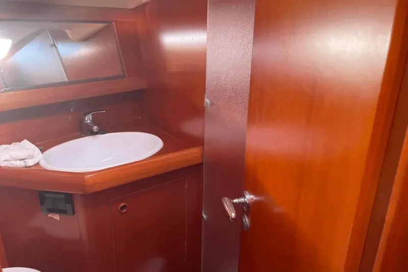  Yacht Photos Pics Interior of 2003 Grand Soleil 43 yacht bathroom with wooden finish and sink.