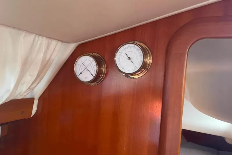  Yacht Photos Pics Interior of 2003 Cantiere del Pardo Grand Soleil 43 with nautical instruments on wooden panel.