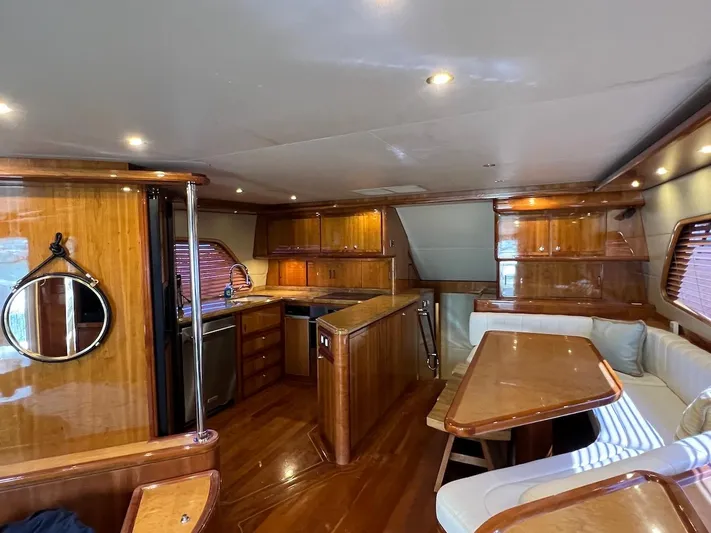  Yacht Photos Pics Luxurious interior of a 2004 Bertram 670 yacht with wooden finishes and modern amenities.