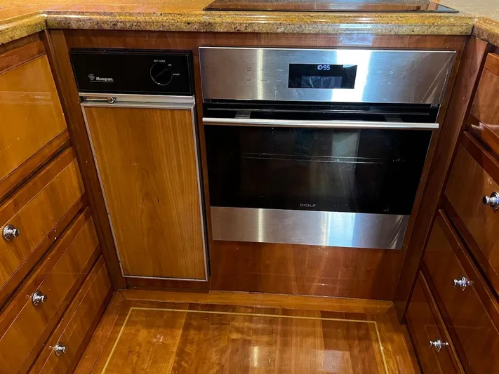  Yacht Photos Pics Modern kitchen in a 2004 Bertram 670 yacht with stainless steel appliances.