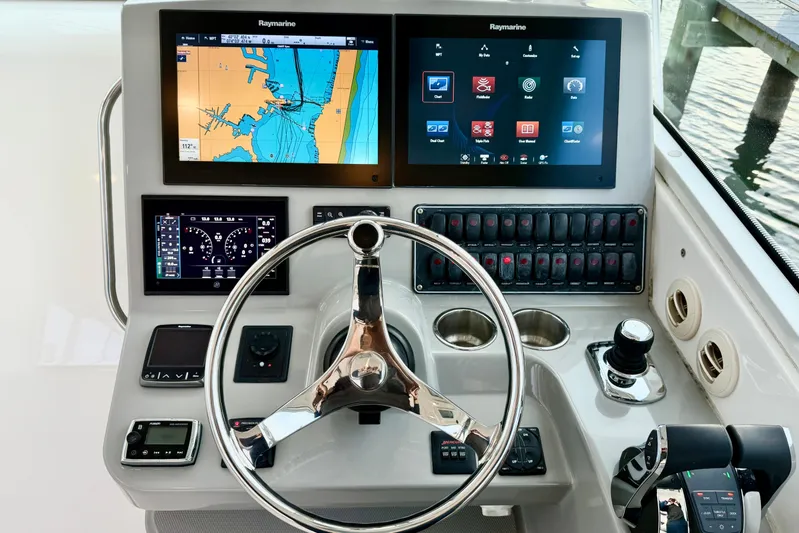  Yacht Photos Pics 2014 Boston Whaler 345 Conquest Pilothouse helm with navigation screens and controls.