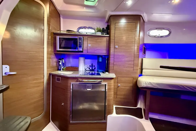  Yacht Photos Pics Interior of 2014 Boston Whaler 345 Conquest Pilothouse with kitchenette and seating area.