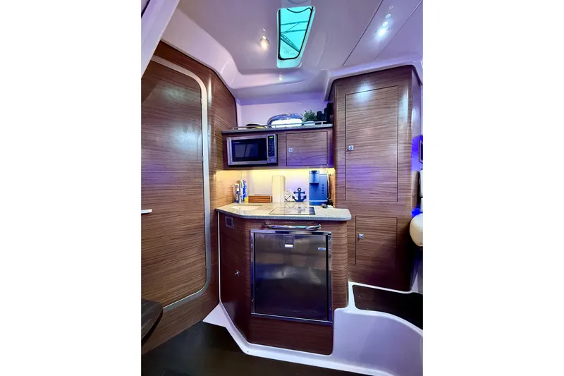  Yacht Photos Pics Luxurious interior of 2014 Boston Whaler 345 Conquest Pilothouse with modern kitchenette.