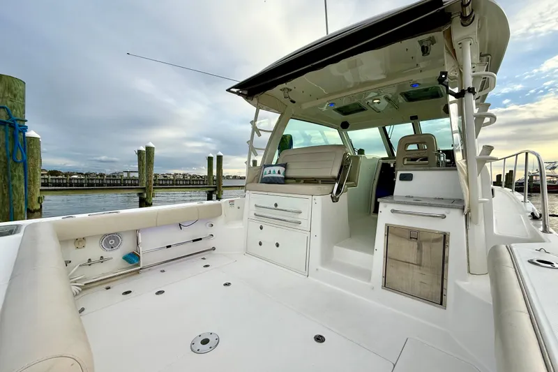  Yacht Photos Pics 2014 Boston Whaler 345 Conquest Pilothouse boat interior at dock, showcasing seating and storage.