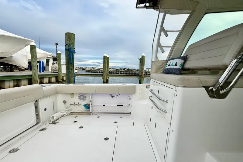  Yacht Photos Pics 2014 Boston Whaler 345 Conquest Pilothouse interior, docked at marina with scenic view.