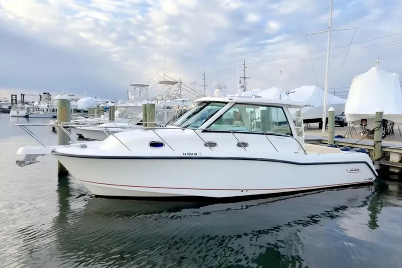  Yacht Photos Pics 2014 Boston Whaler 345 Conquest Pilothouse docked at marina under cloudy sky.