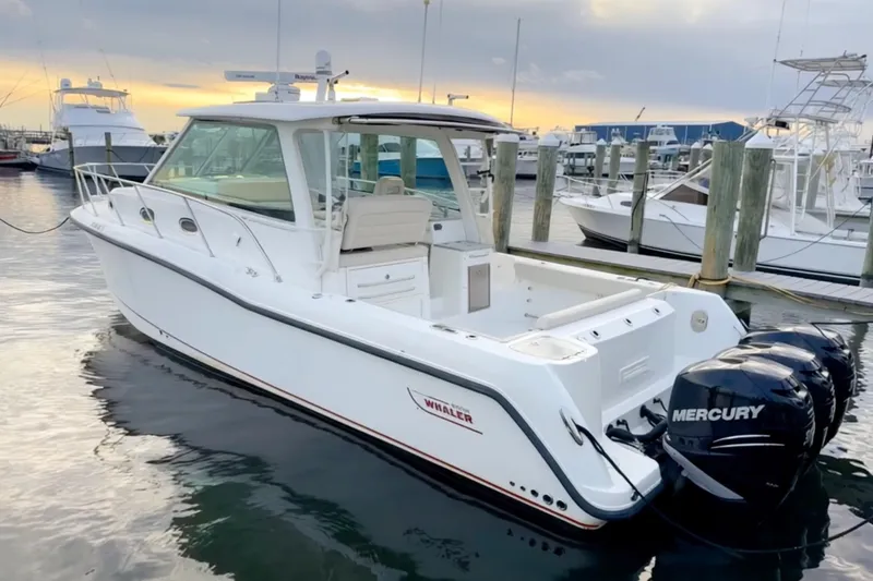  Yacht Photos Pics 2014 Boston Whaler 345 Conquest Pilothouse docked at marina during sunset.