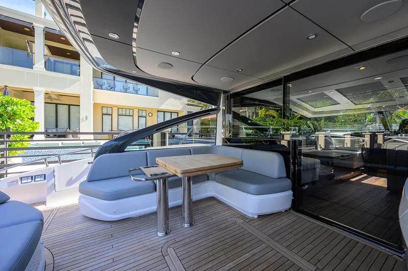 Ladybird Yacht Photos Pics Luxurious 2025 Princess V55 yacht with sleek deck seating and modern design.