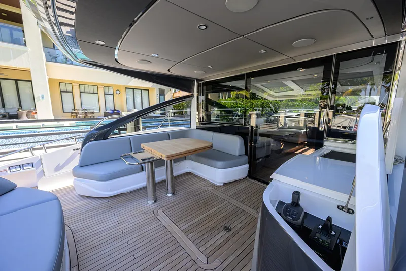 Ladybird Yacht Photos Pics Luxurious 2025 Princess V55 yacht interior with sleek seating and modern design.