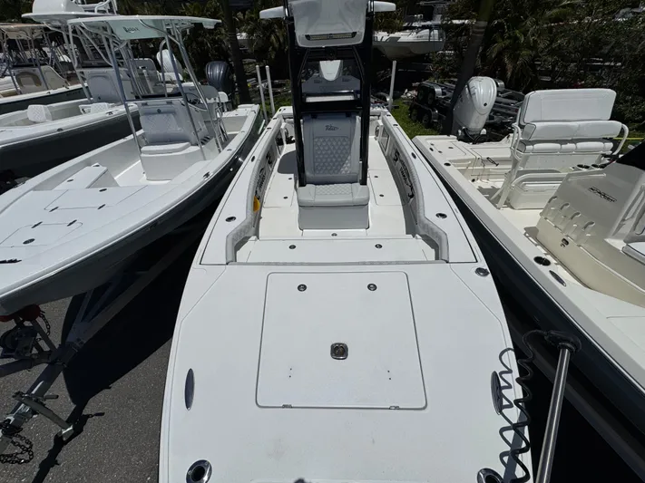  Yacht Photos Pics 2024 Tides 26 boat, sleek design, parked among other boats.