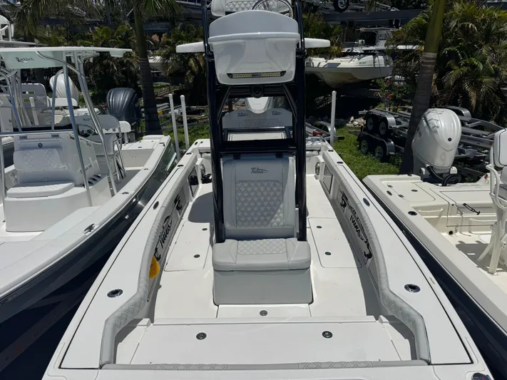  Yacht Photos Pics 2024 Tides 26 boat with sleek design, white seating, and modern features, docked outdoors.