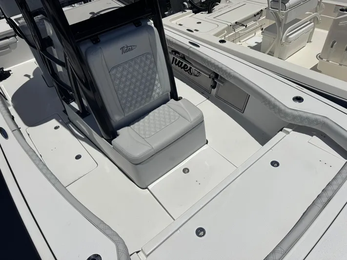  Yacht Photos Pics 2024 Tides 26 boat interior with cushioned seating and sleek design.