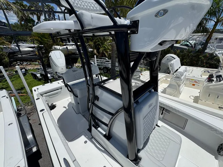  Yacht Photos Pics 2024 Tides 26 boat interior with seating and console, surrounded by other boats.