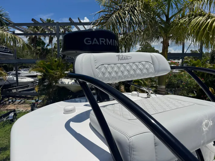  Yacht Photos Pics 2024 Tides 26 boat seat with diamond stitching, surrounded by palm trees and boats.