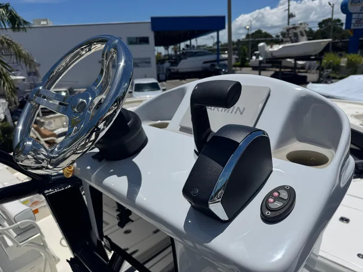  Yacht Photos Pics 2024 Tides 26 boat helm with chrome steering wheel and control panel.