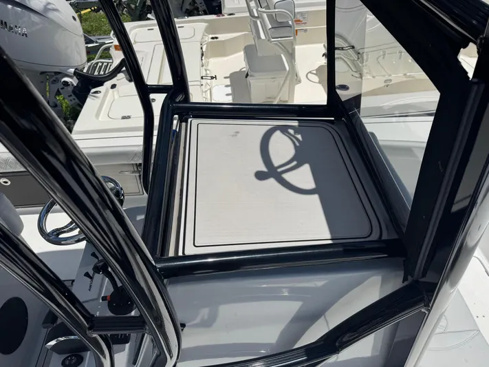  Yacht Photos Pics 2024 Tides 26 boat helm station with steering wheel and controls.