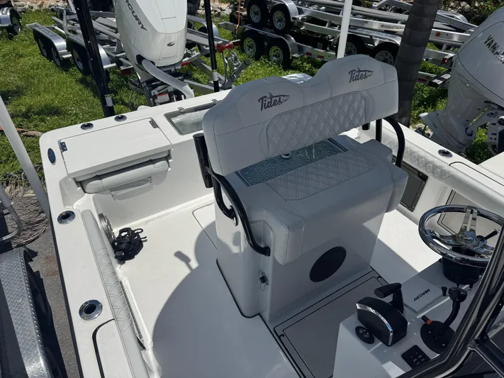  Yacht Photos Pics 2024 Tides 26 boat interior with steering wheel and seating, featuring Mercury engine.