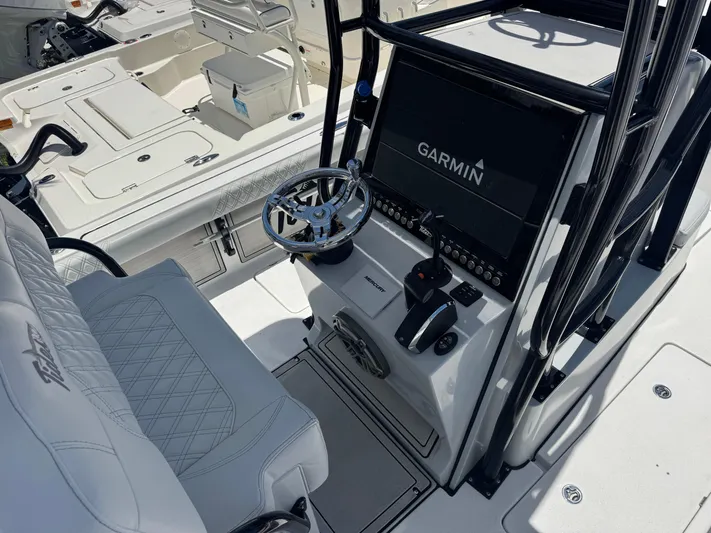  Yacht Photos Pics 2024 Tides 26 boat cockpit with Garmin navigation system and luxurious seating.