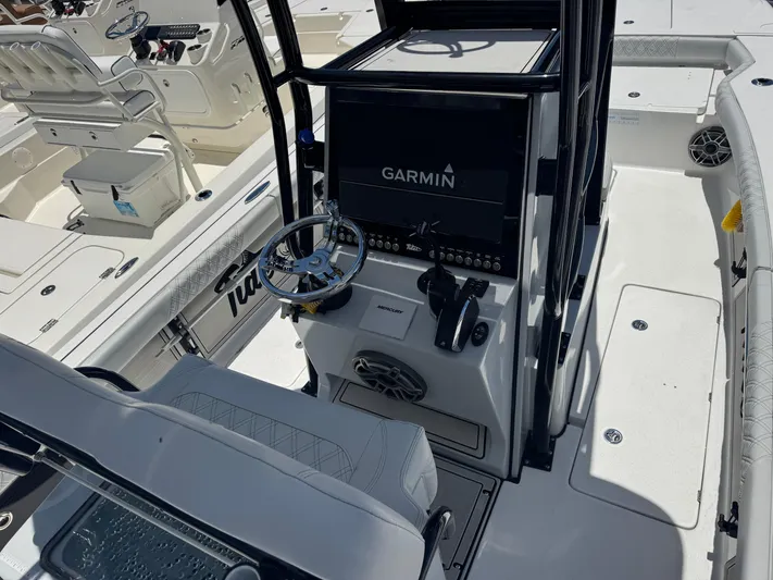  Yacht Photos Pics 2024 Tides 26 boat cockpit with Garmin navigation system and steering wheel.