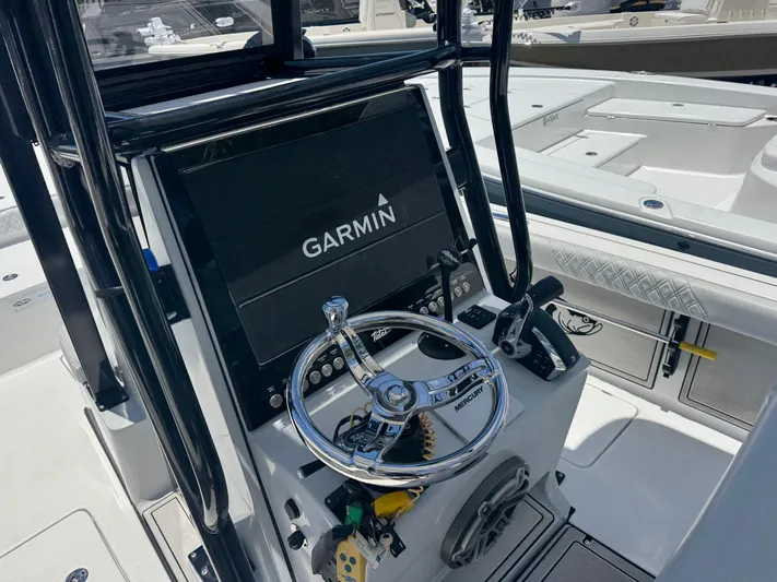 Yacht Photos Pics 2024 Tides 26 boat dashboard with Garmin display and Mercury steering wheel.
