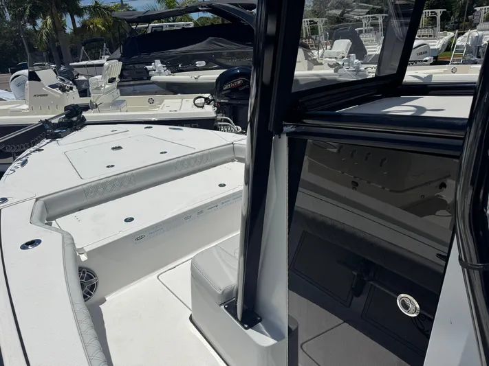  Yacht Photos Pics 2024 Tides 26 boat interior with seating and console, showcasing modern design and functionality.