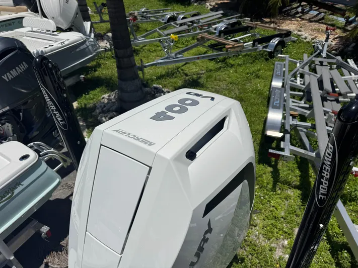  Yacht Photos Pics 2024 Tides 26 boat with Mercury engine and Power-Pole anchors, surrounded by trailers.