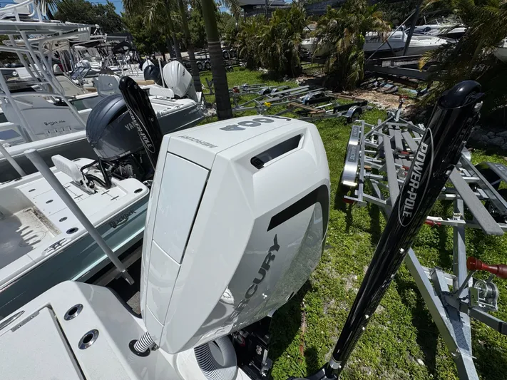  Yacht Photos Pics 2024 Tides 26 boat with Mercury outboard engine and Power-Pole anchors in a marina.