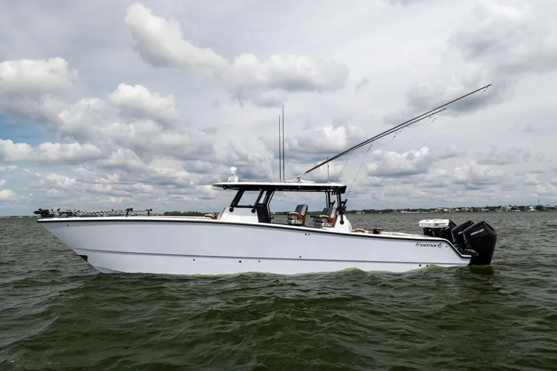  Yacht Photos Pics 2025 Freeman 42 LR boat on water under cloudy sky.