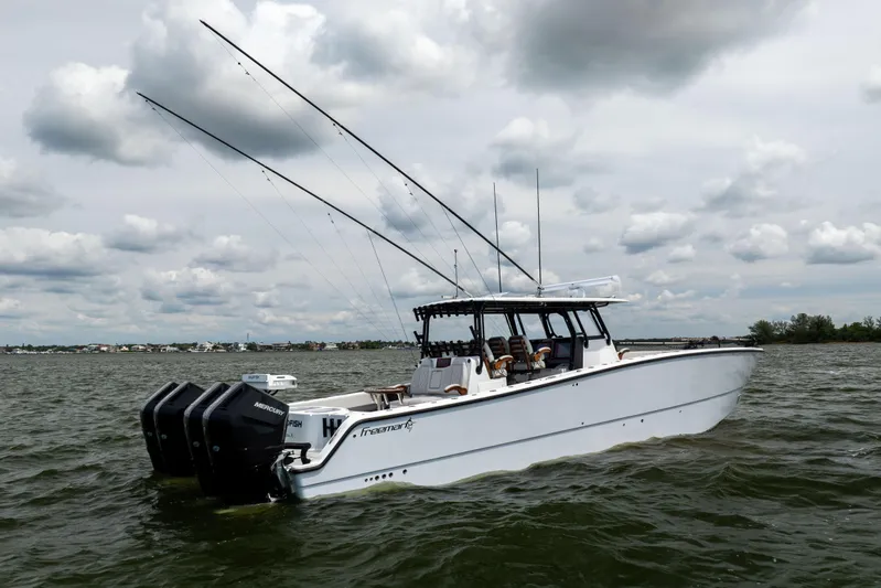  Yacht Photos Pics 2025 Freeman 42 LR boat on water with fishing rods and Mercury engines.