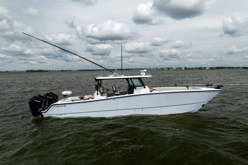  Yacht Photos Pics 2025 Freeman 42 LR boat on water, featuring sleek design and multiple outboard engines.